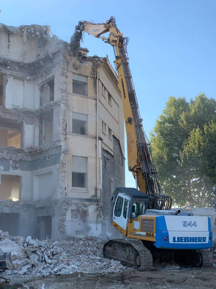 Démolition mécanique d'un immeuble de bureau de grande hauteur à l'aide d'une pelle grand bras en région PACA